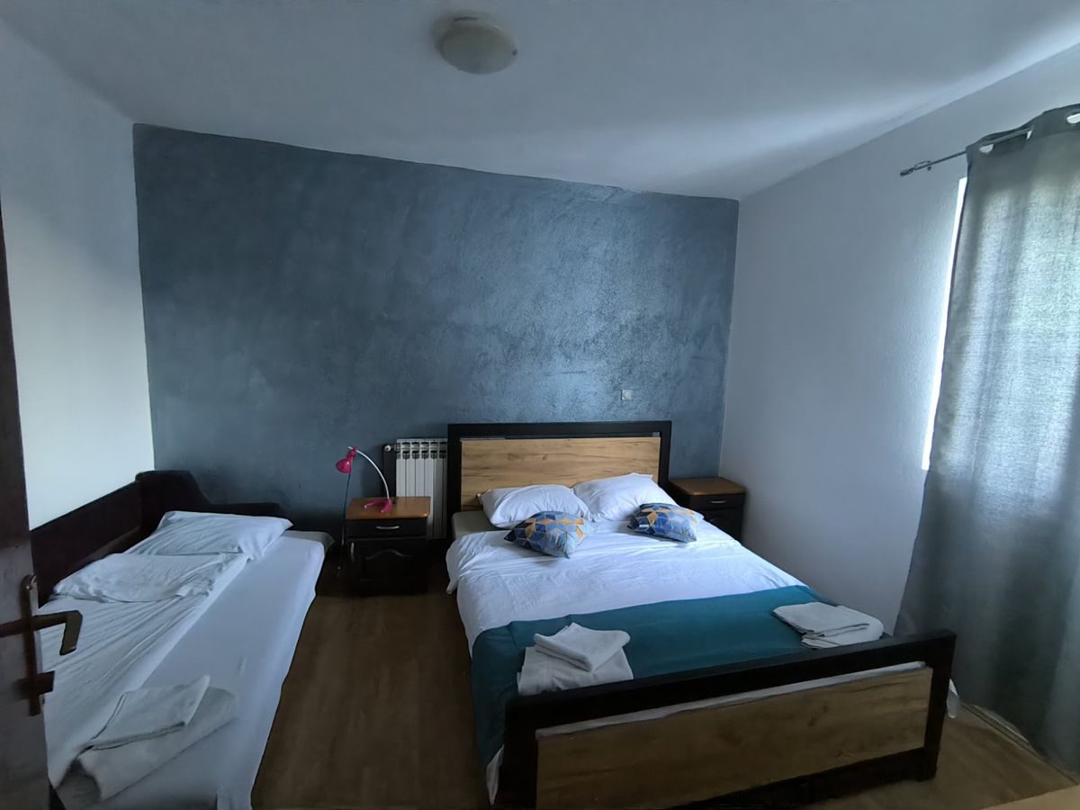 Apartment bedroom with a double bed and a single bed